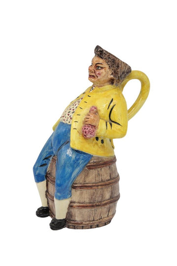 Original pitcher in barbotine representing a fat man sitting on a barrel