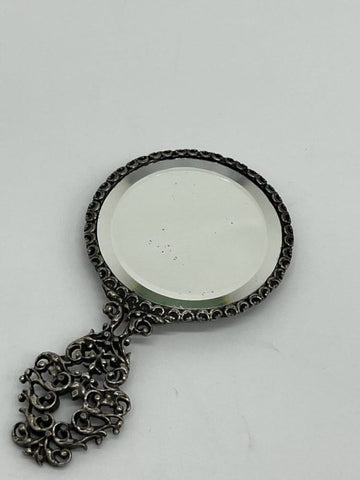 Small collection mirror in silver metal with chiselled decor of a concert scene