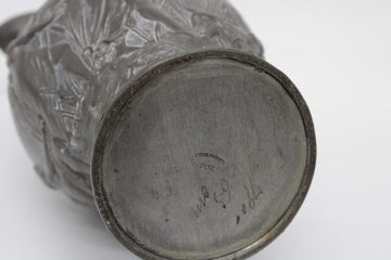 Stylish Nil model pewter jug, with a molded decor on the body signed
