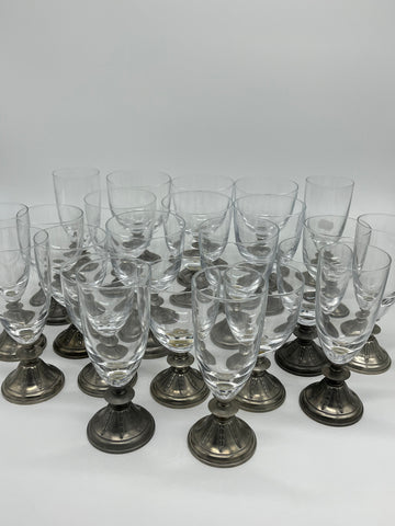 A service of glasses, pewter base, eight champagne glasses, eight water glasses and seven wine glasses