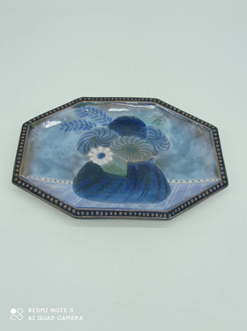 Blue plate with flower decoration by the artist Cloutier