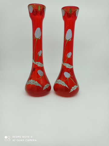 Vase with low body and long neck in red glass with enameled thistle decoration