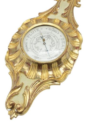 Decorative weather barometer in carved, lacquered and gilded wood.