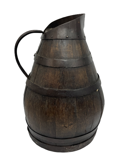 Authentic large wooden pitcher surrounded by metal