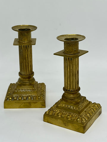 Pair of candlesticks with fluted shaft resting on a stepped base decorated with a heart stripe