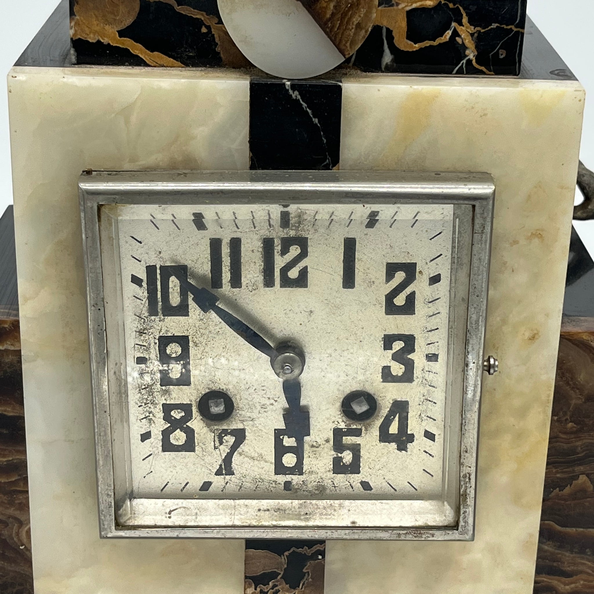 a marble clock with statue