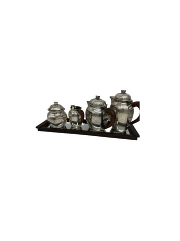 Elegant French tea and coffee service with silvery metal sides, tinted wooden handle. Coffee maker, a teapot, a milk jug and a sugar bowl. Rectangular rosewood tray with an ice base. Art Deco style